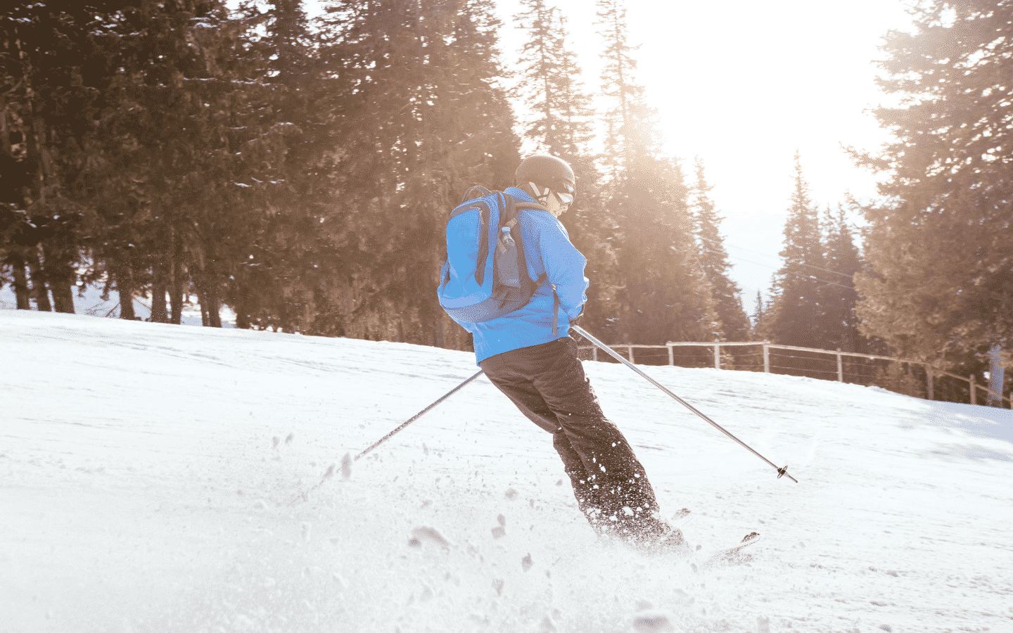 Downhill skier in a blue cloat.