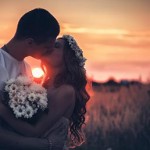 wedding couple kissing at sunset