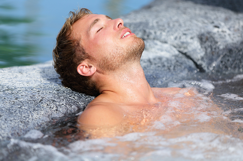 Man Relaxing in Hot Springs Tub