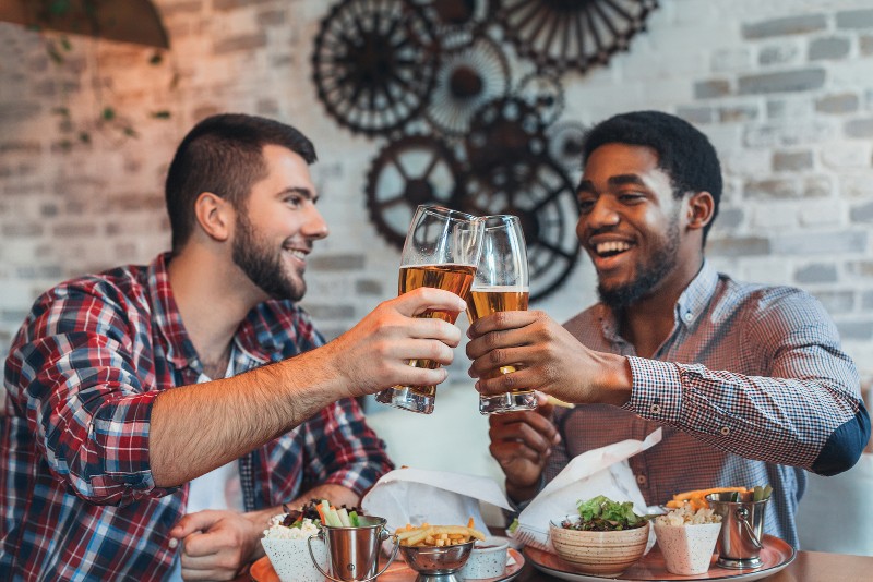 two men enjoying a beer