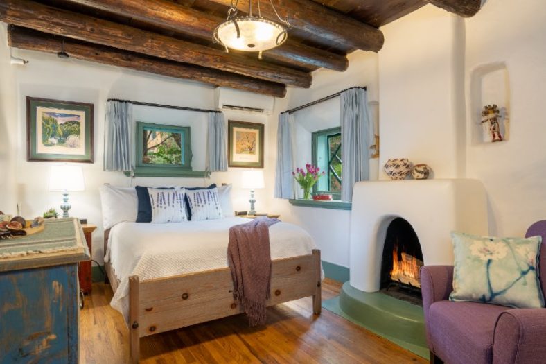 Beautiful O Henry guest room, two windows, queen sized bed, fire in fireplace and sitting chair
