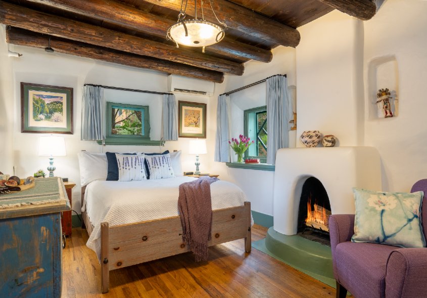 Beautiful O Henry guest room, two windows, queen sized bed, fire in fireplace and sitting chair