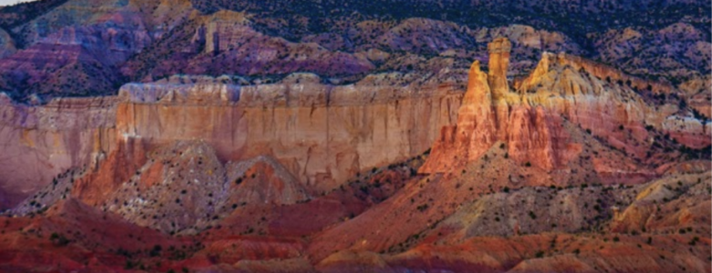 New Mexico mountains in shades of pink, burgundy and purple