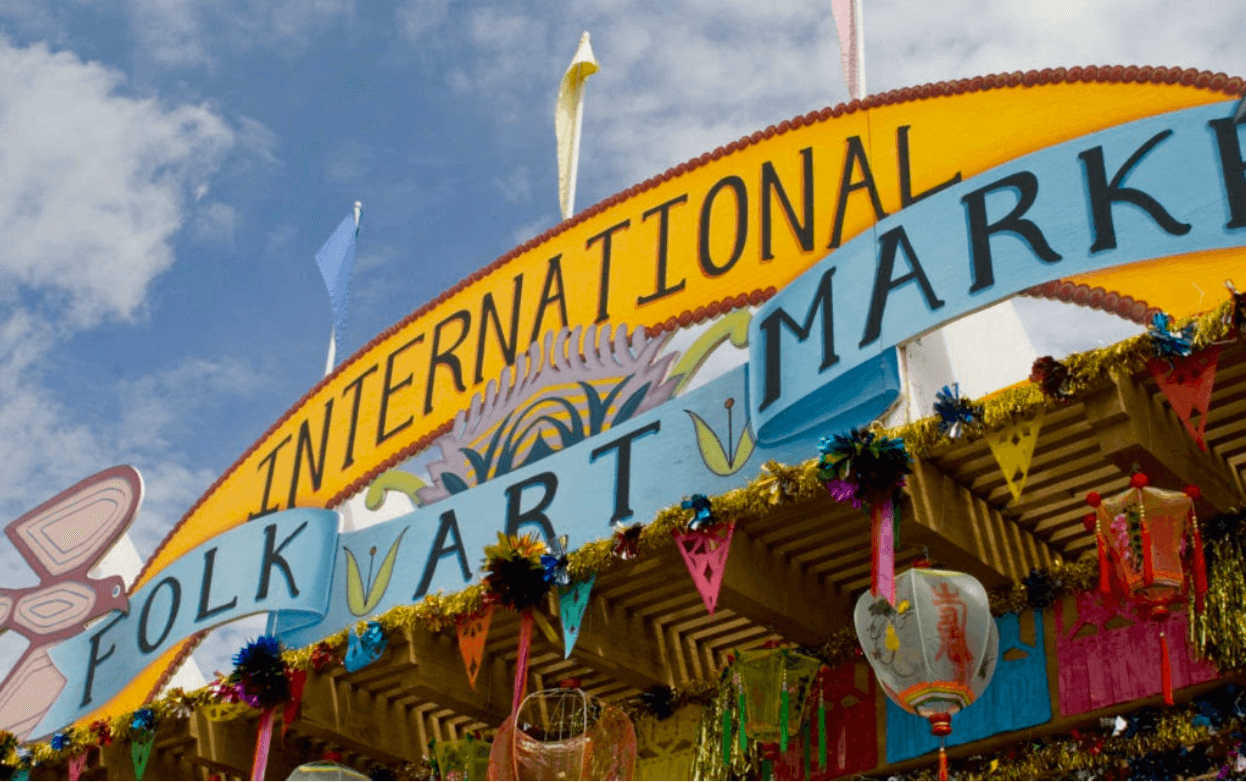 Exterior view of large sign that says International Folk Art Market