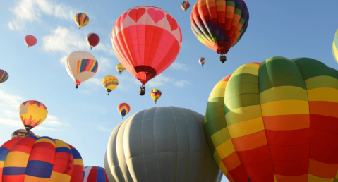 Colorful hot air balloons rising into the sky.