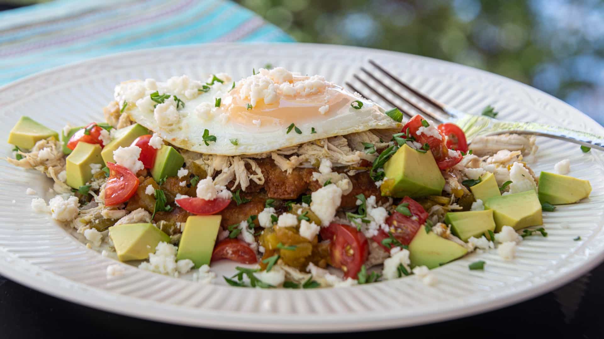 New Mexican Sope topped with shredded Chicken, Green Chile, Egg, Avocado, Diced Tomatoes, and queso Fresco