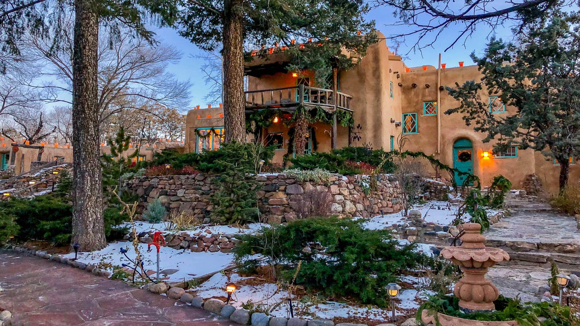 Inn of the Turquoise Bear adorned with Farolitos and evergreen garland