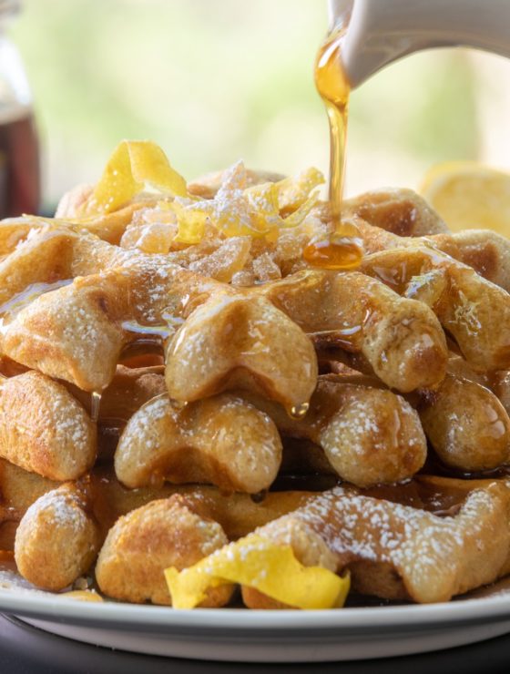 Lemon Ginger Waffles topped with chopped candied ginger and syrup