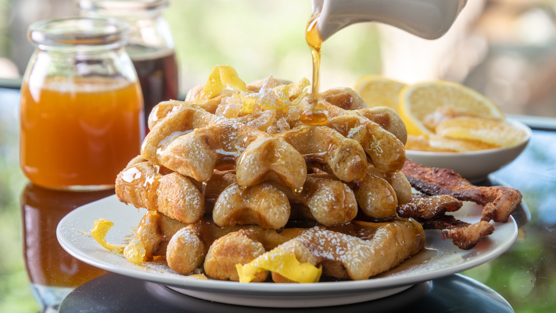 Lemon Ginger Waffles topped with chopped candied ginger and syrup