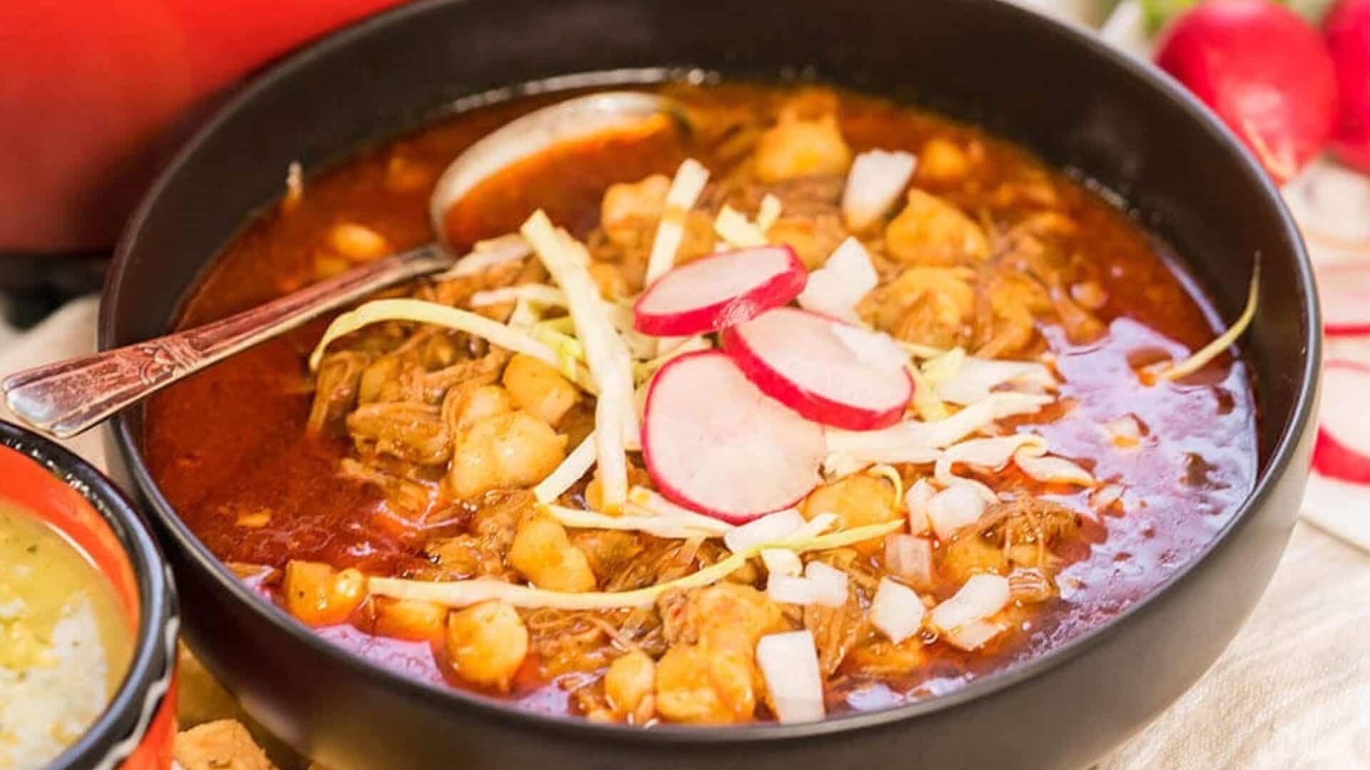Bowl of New Mexico Posole Rojo with sliced cabbage, radish.