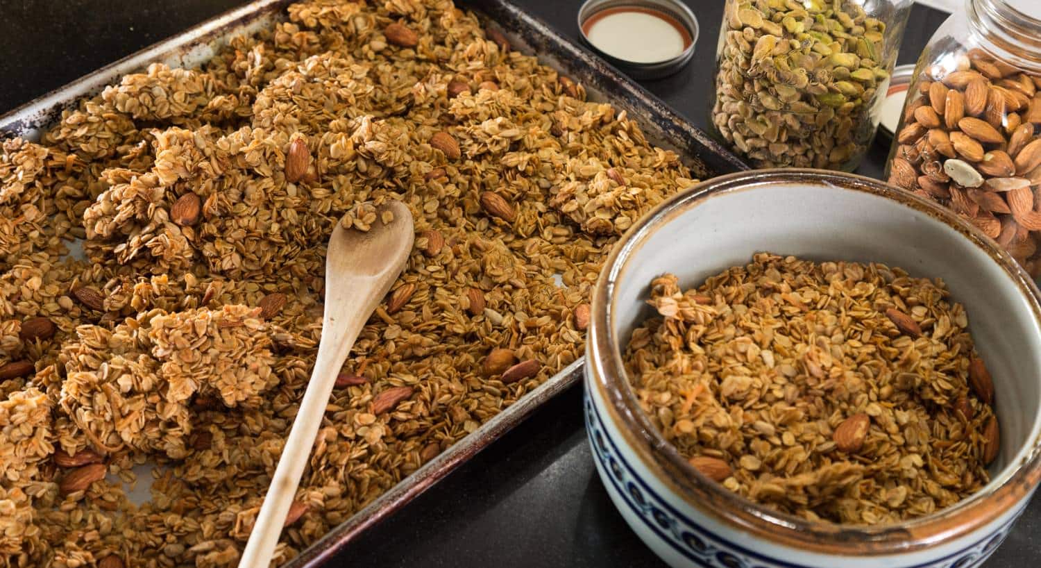 Close up view of homemade granola in baking tray and bowl