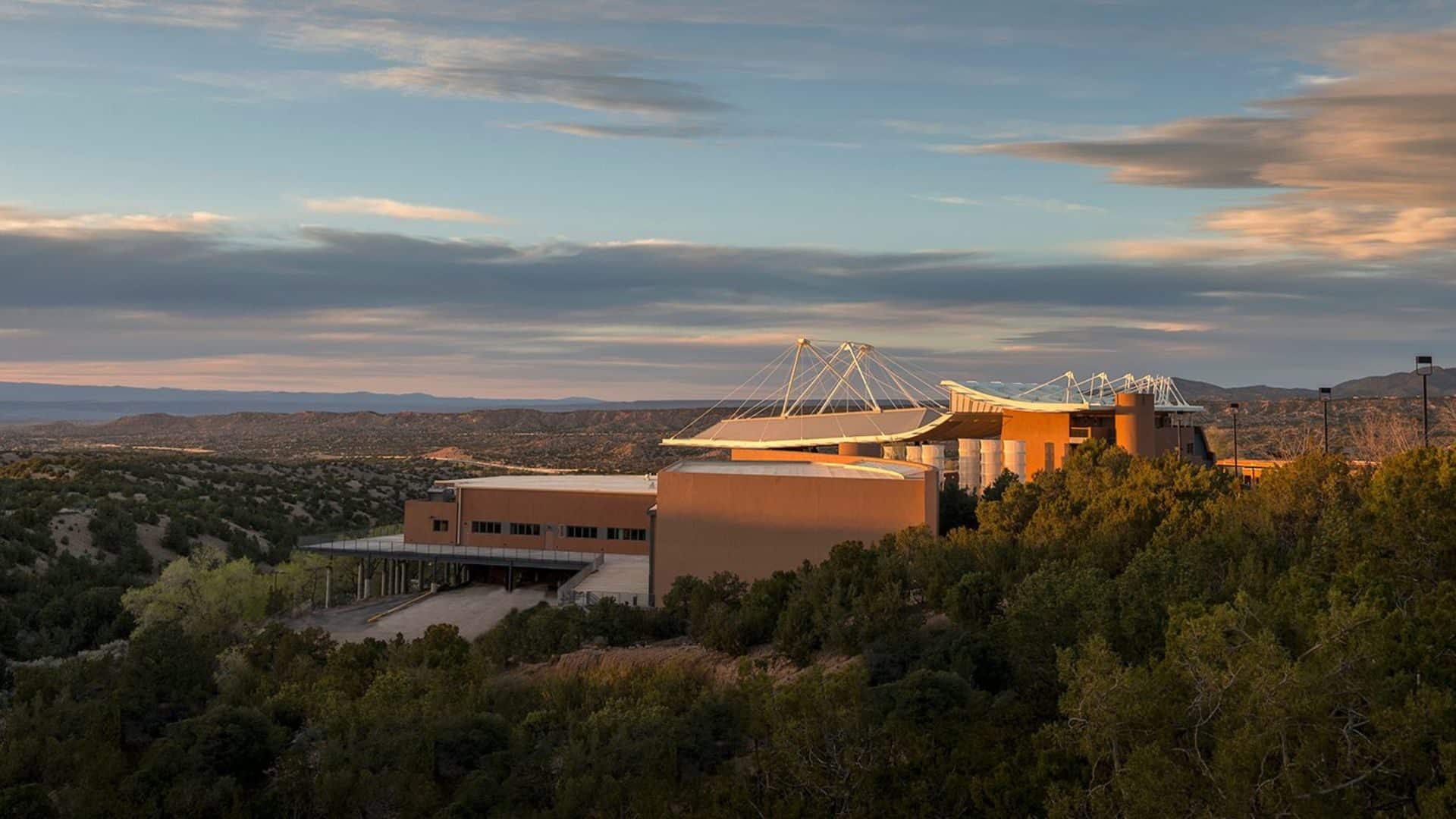 Aerial view of the Santa Fe Opera, an orange uniquely shaped building with white roof. Photo by Robert Godwin.