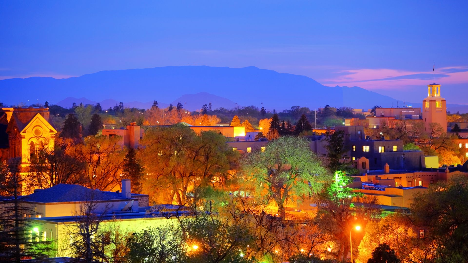 Aerial view of Santa Fe at dusk lit up by colorful night lights