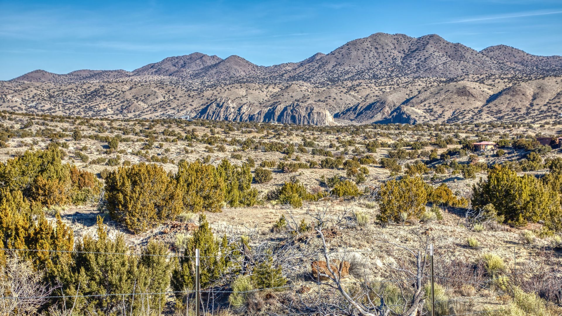 Turquoise Scenic Byway surrounded by desert landscape, mountains, and blue skies.