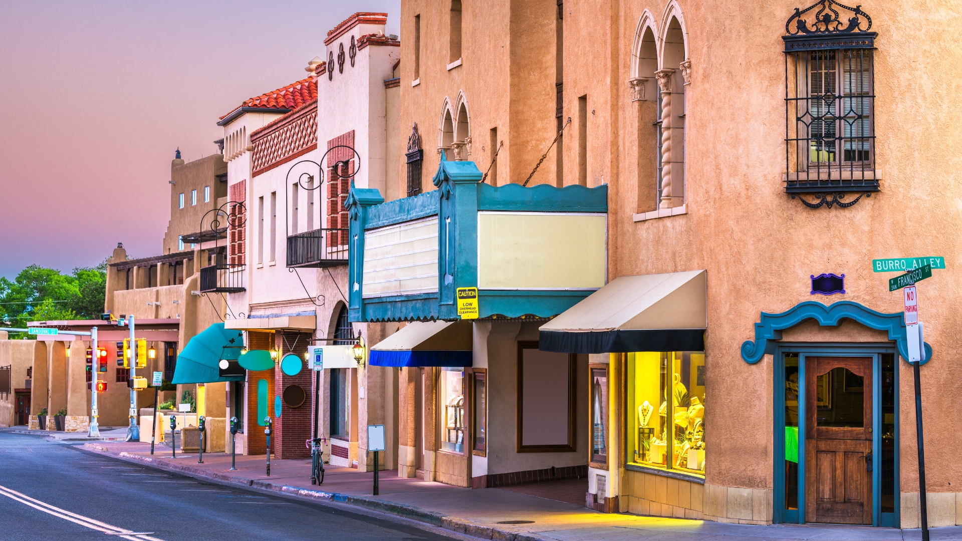 Adobe buildings in downtown Santa Fe illuminated by pink skies of dusk