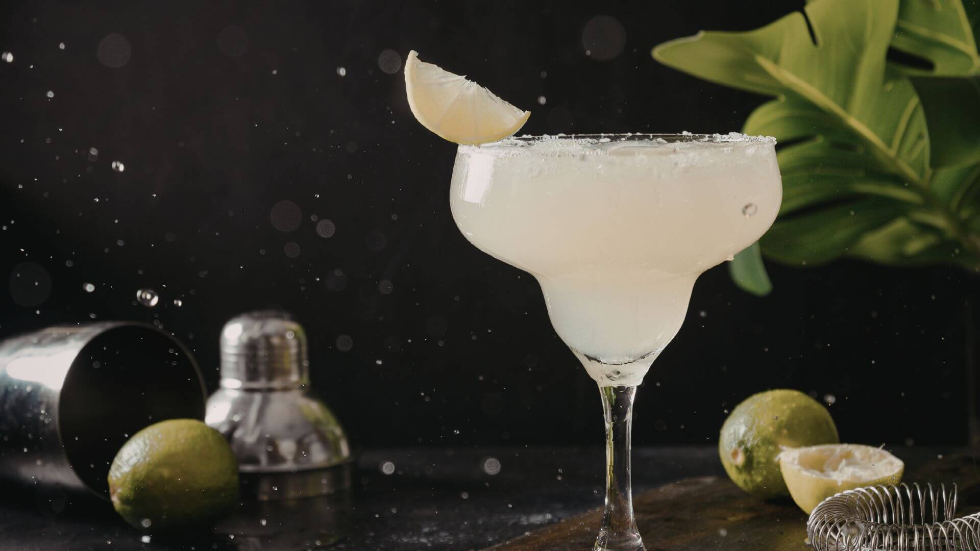 Fresh lime margarita in a salt rimmed glass with lime wedge garnish