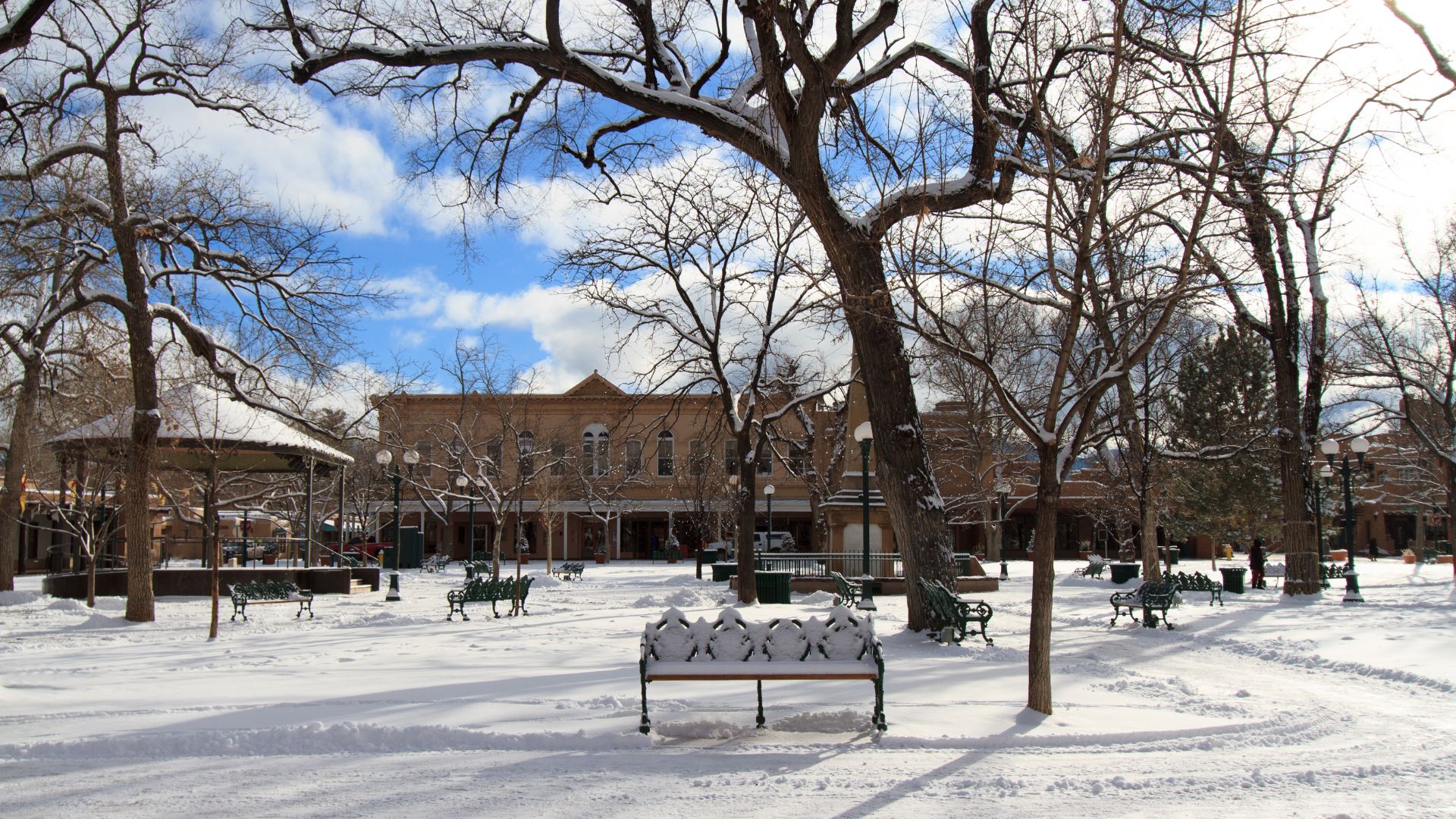 Santa Fe's downtown plaza covered in fresh white snow.