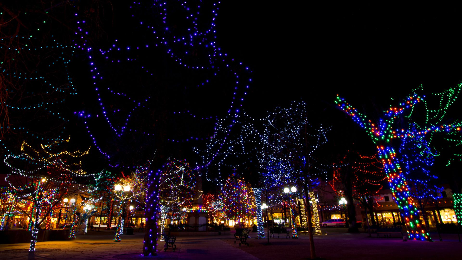 Santa Fe Plaza lit up at night with thousands of different colored twinkle lights.