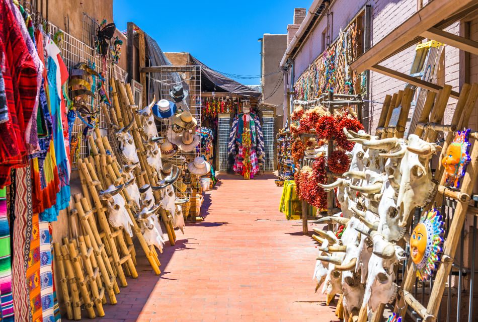 Bright and beautiful alley market with ladders, textiles, bull skulls and Southwestern pottery.